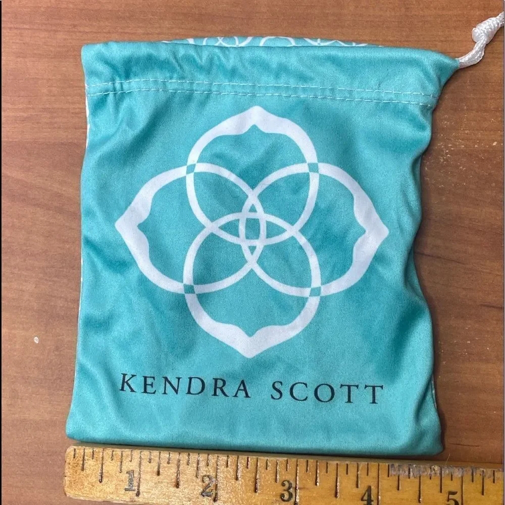 Kendra Scott jewelry bag in turquoise with white signature pattern drawstring
